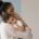 a mother holds her baby and considers how to wean them from breastfeeding.
