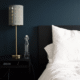 Bed with pillows, dark headboard, and lamp, getting help with newborn sleep in Towson, Baltimore, Hunt Valley, Owings Mills, Lutherville