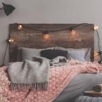 Grey and pastel pink blanket on grey bedding of fashionable bedroom cozy for long winter nights newborn overnight care
