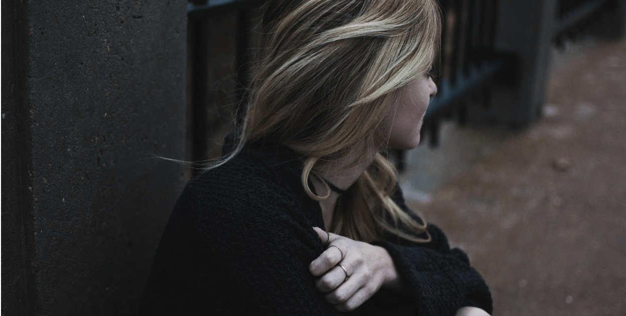 New mom looking away. Postpartum doula helps with wintertime blues and postpartum depression