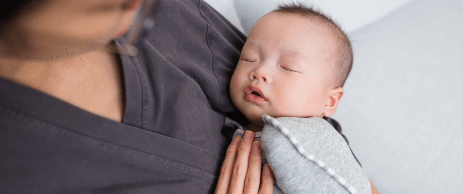 a baby is held by their professional postpartum doula