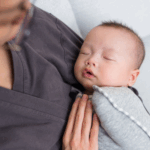 a baby is held by their professional postpartum doula