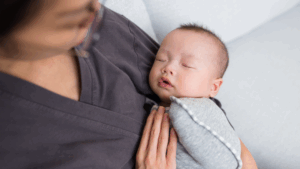 a baby is held by their professional postpartum doula