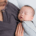 a baby is held by their professional postpartum doula
