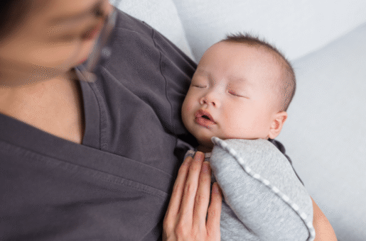 a baby is held by their professional postpartum doula