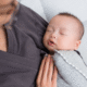 a baby is held by their professional postpartum doula