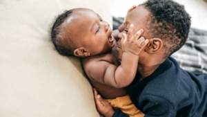 New brother holds their baby sibling