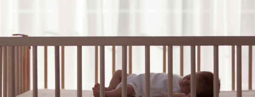 Baby sleeping safely on back in crib