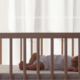 Baby sleeping safely on back in crib