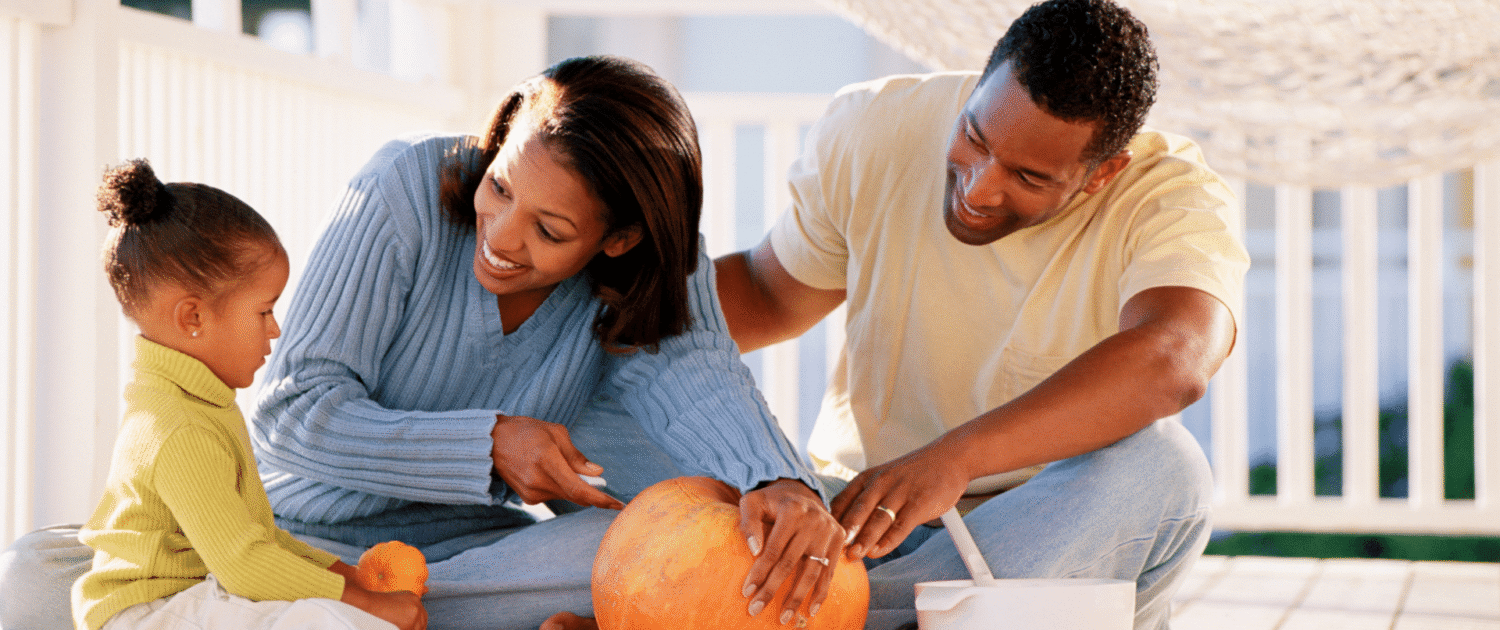 Fall fun, pumpkin carving family on Baltimore porch