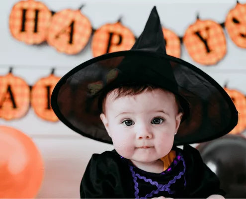 Baby in witch hat, halloween banner, witching hour