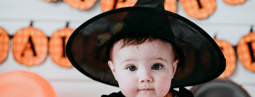 Baby in witch hat, halloween banner, witching hour