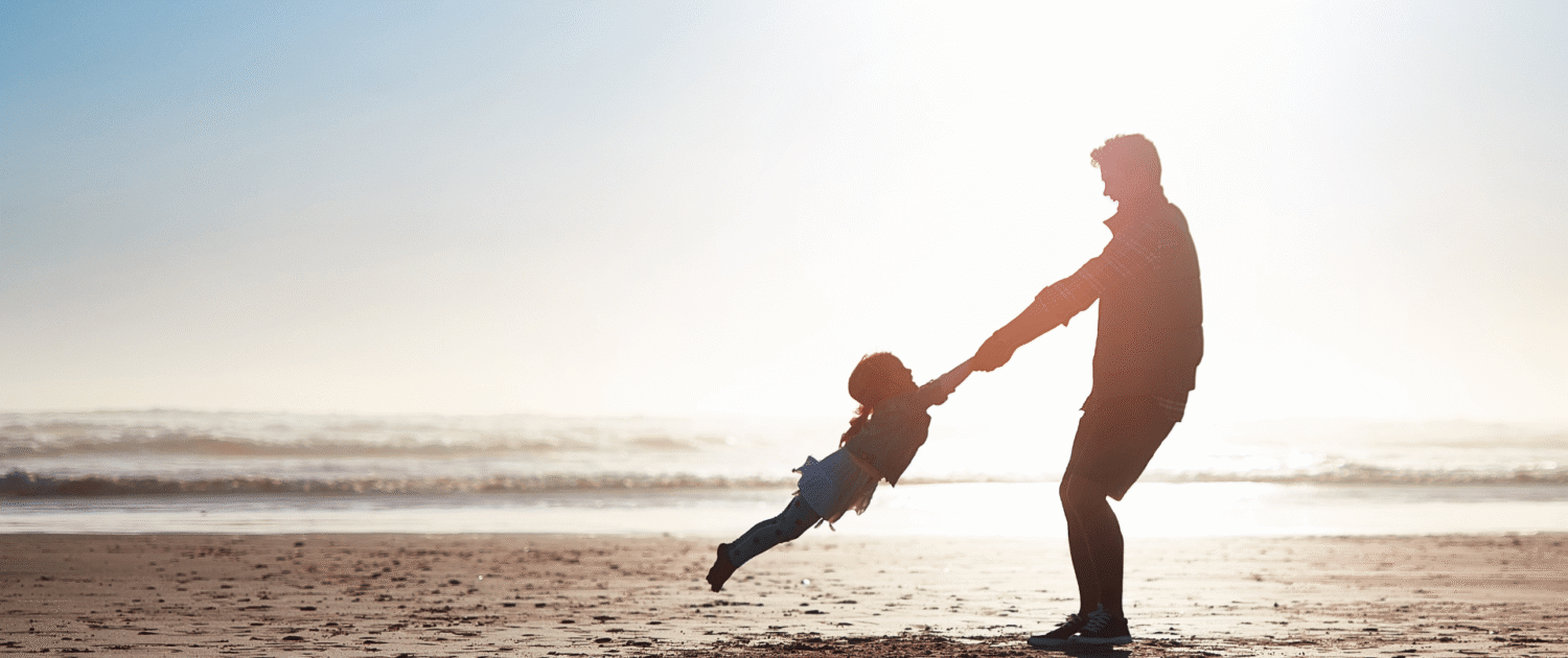 parent and child on a sunny beach, preparing for daylight savings time with baby child
