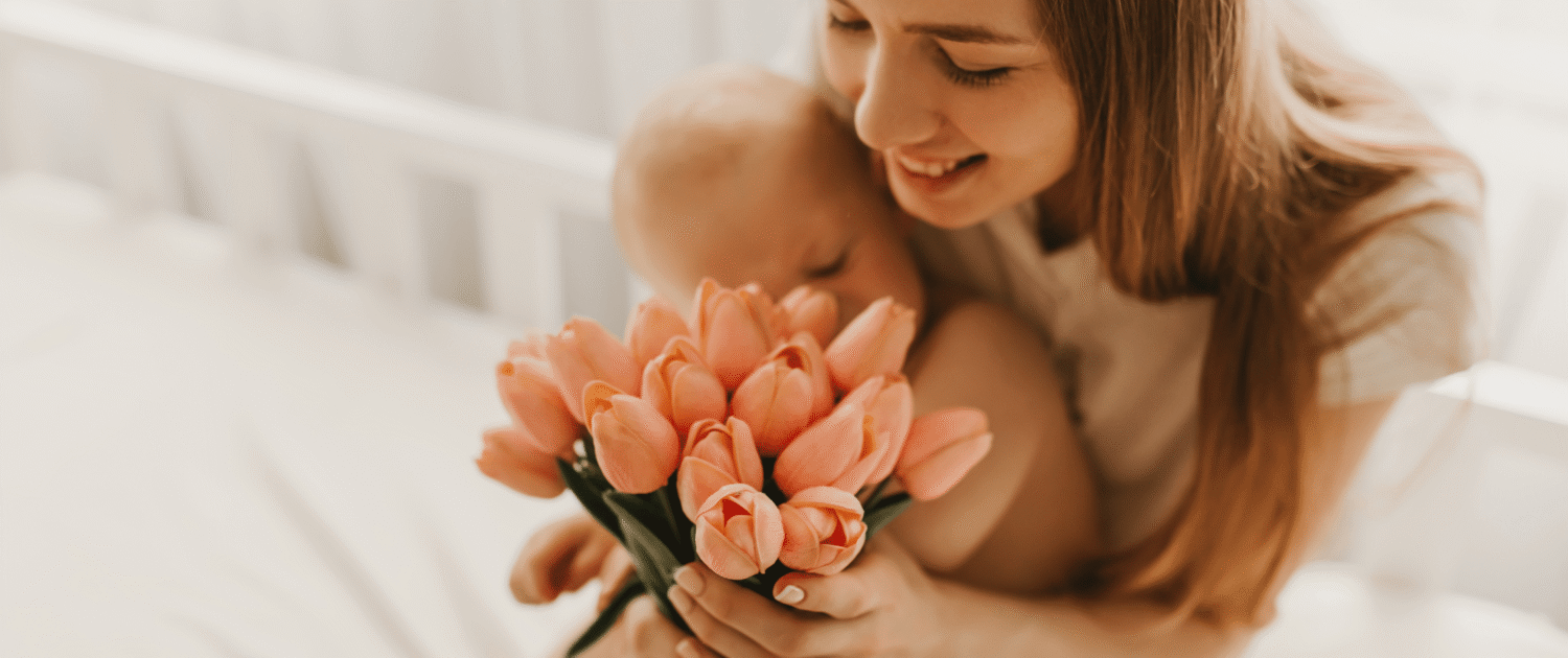 A new mother smiles at a gift she recieved for mother's day