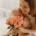 A new mother smiles at a gift she recieved for mother's day