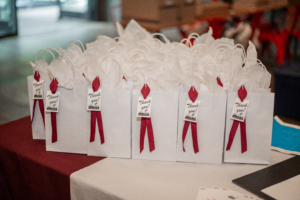 Party favors for a birthday party featuring a red bow and a tag that says "thank you!"