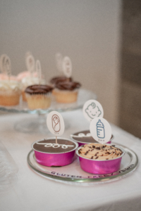 Gluten-free treats featuring babies and bottles adorn the tables at the tenth birthday party for Doulas of Baltimore.