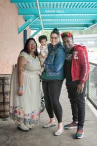 Happy clients pose alongside Rae with Doulas of Baltimore.