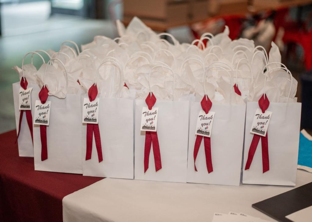 Party favors for a birthday party featuring a red bow and a tag that says "thank you!"