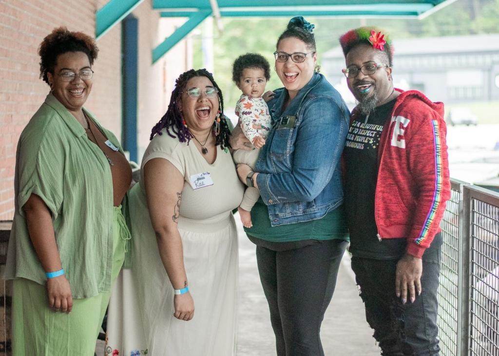 Happy clients pose alongside Rae with Doulas of Baltimore.