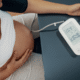 Pregnant individual takes their blood pressure to monitor for hypertension, preeclampsia, or hellp in pregnancy.