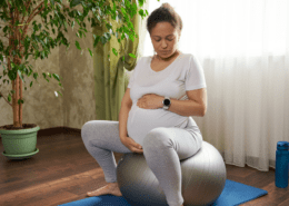 A pregnant person sits on a yoga ball during early labor as a comfort and distraction technique.