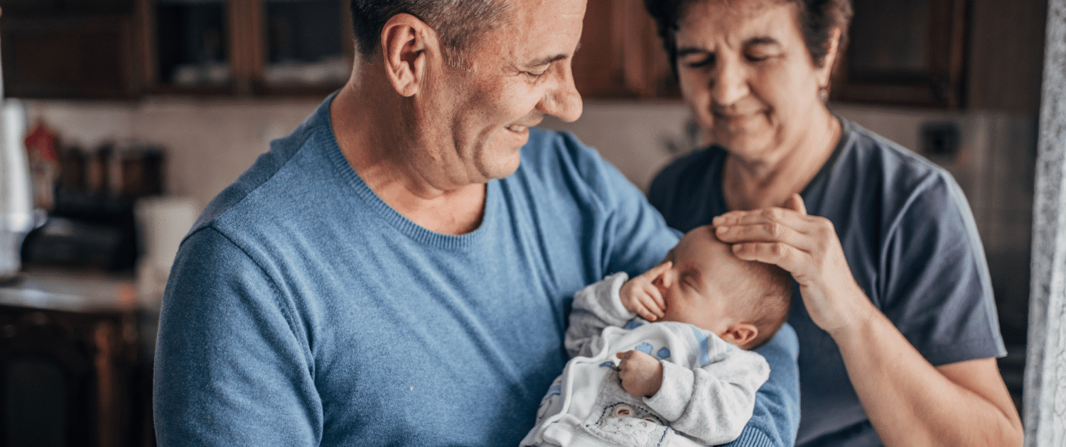 A newborn baby meets their grandparents for the first time.