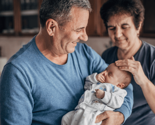 A newborn baby meets their grandparents for the first time.