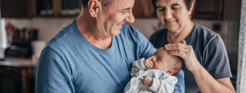 A newborn baby meets their grandparents for the first time.