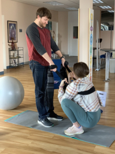 A partner works with their pregnant partner to support them during labor.