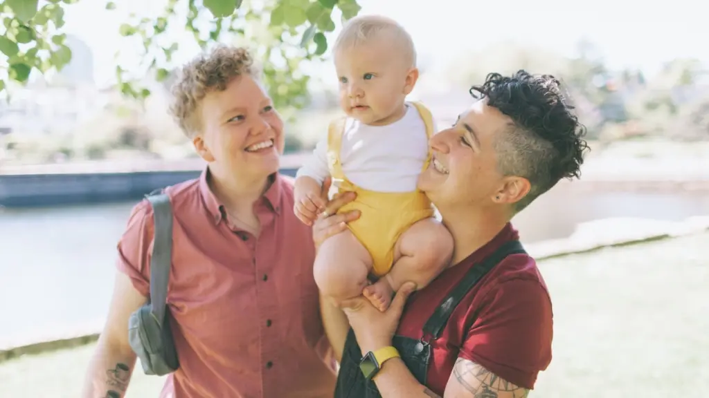 Nonbinary parents join their baby in the sunshine at parks in Baltimore, Maryland.