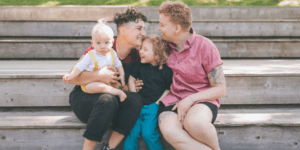 An LGBT family spends time together on the steps at a park in Baltimore, Maryland