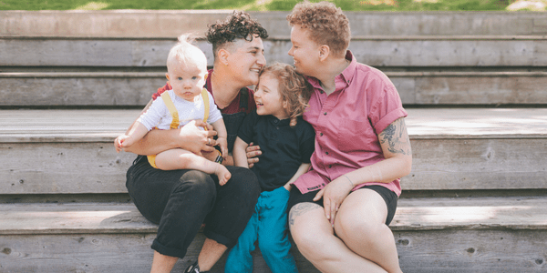 An LGBT family spends time together on the steps at a park in Baltimore, Maryland